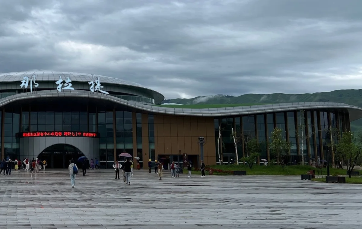 Visitors outside a gateway building in Nalati
