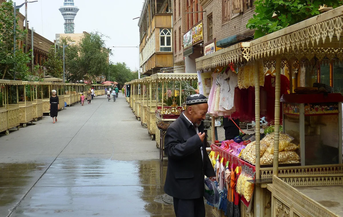 A vendor beside a shop in Kashgar old town