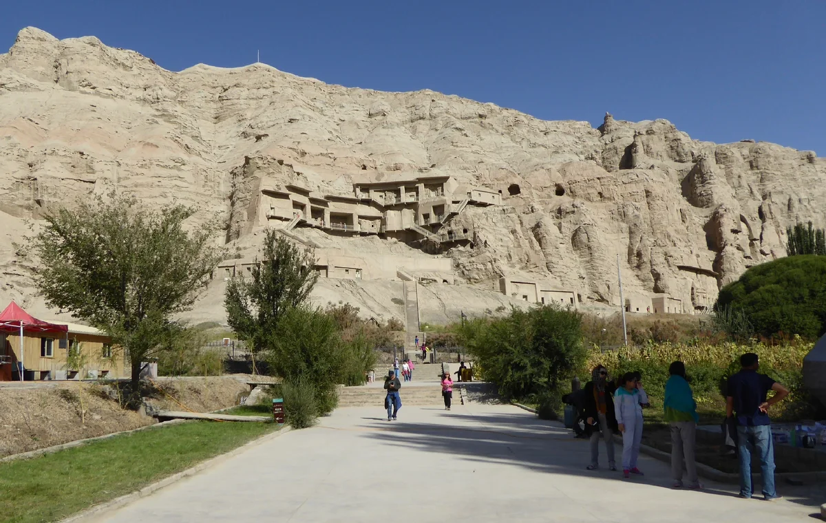 Visitors approaching the Kizil Cave Temple Complex near Kuqa