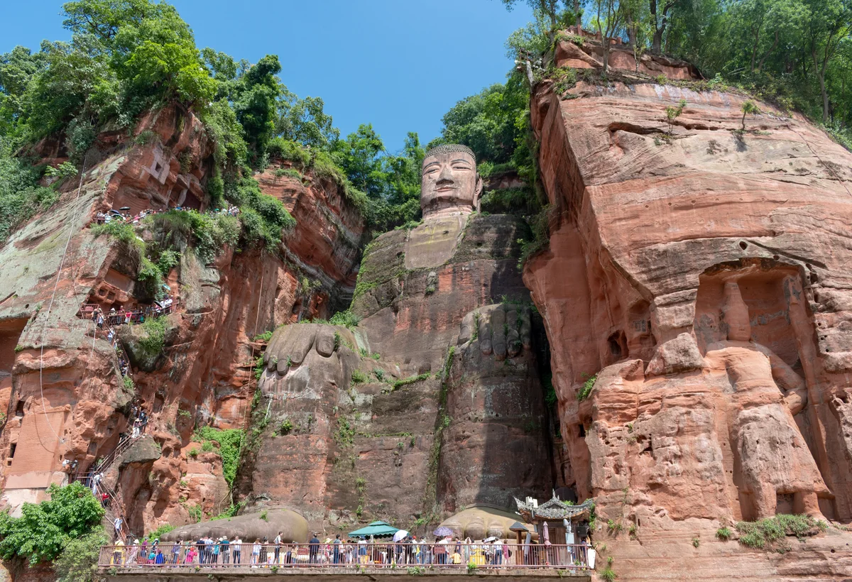 Leshan Giant Buddha carved into a red cliff above the river