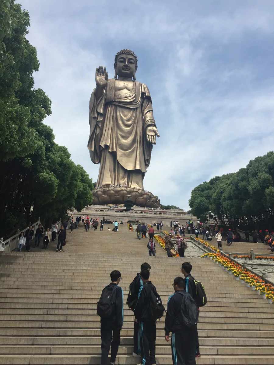 Visitors walking up the broad approach to the Lingshan Grand Buddha in Wuxi