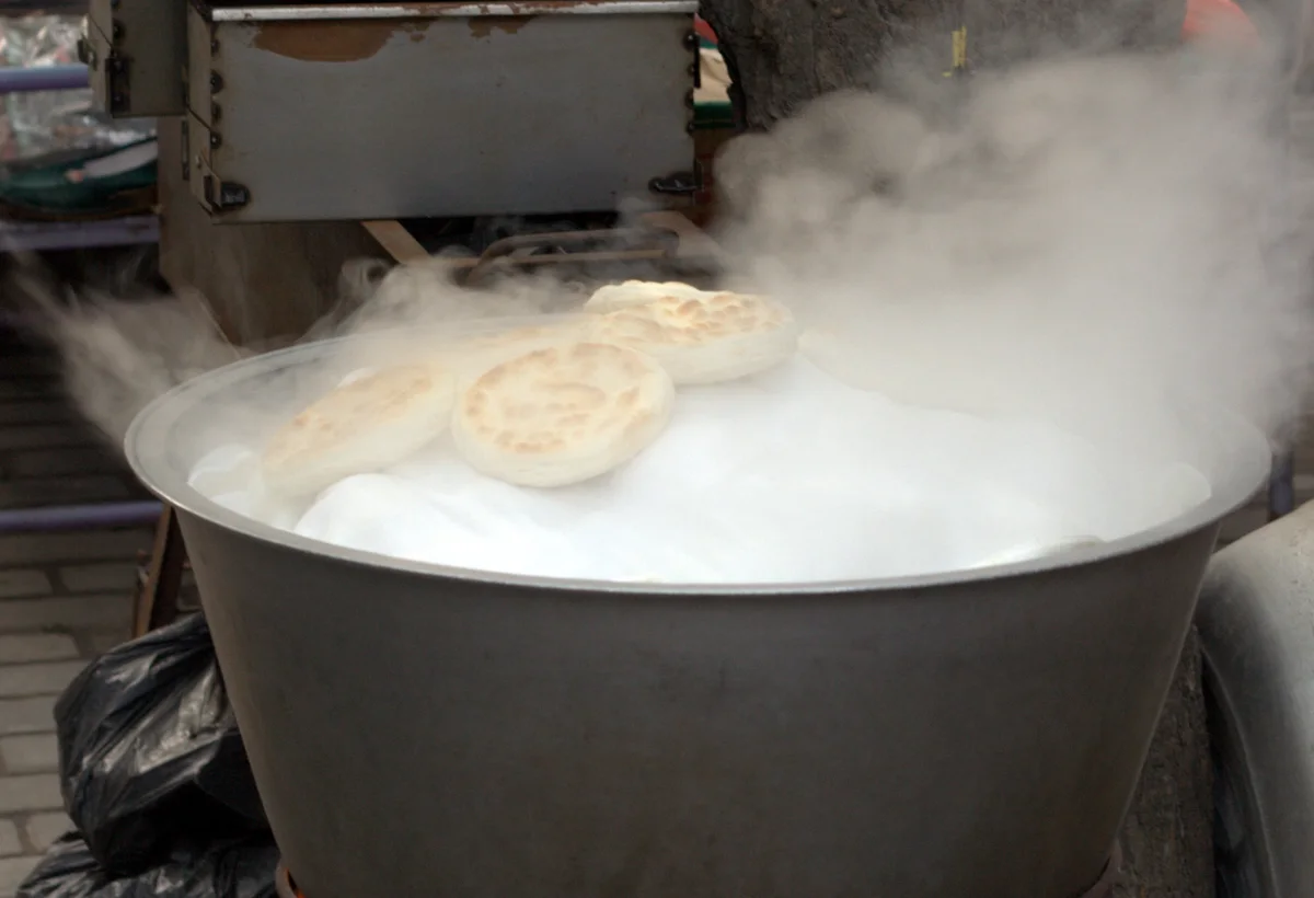 Fresh flatbreads steaming in a food stall in Xi'an's Muslim Quarter