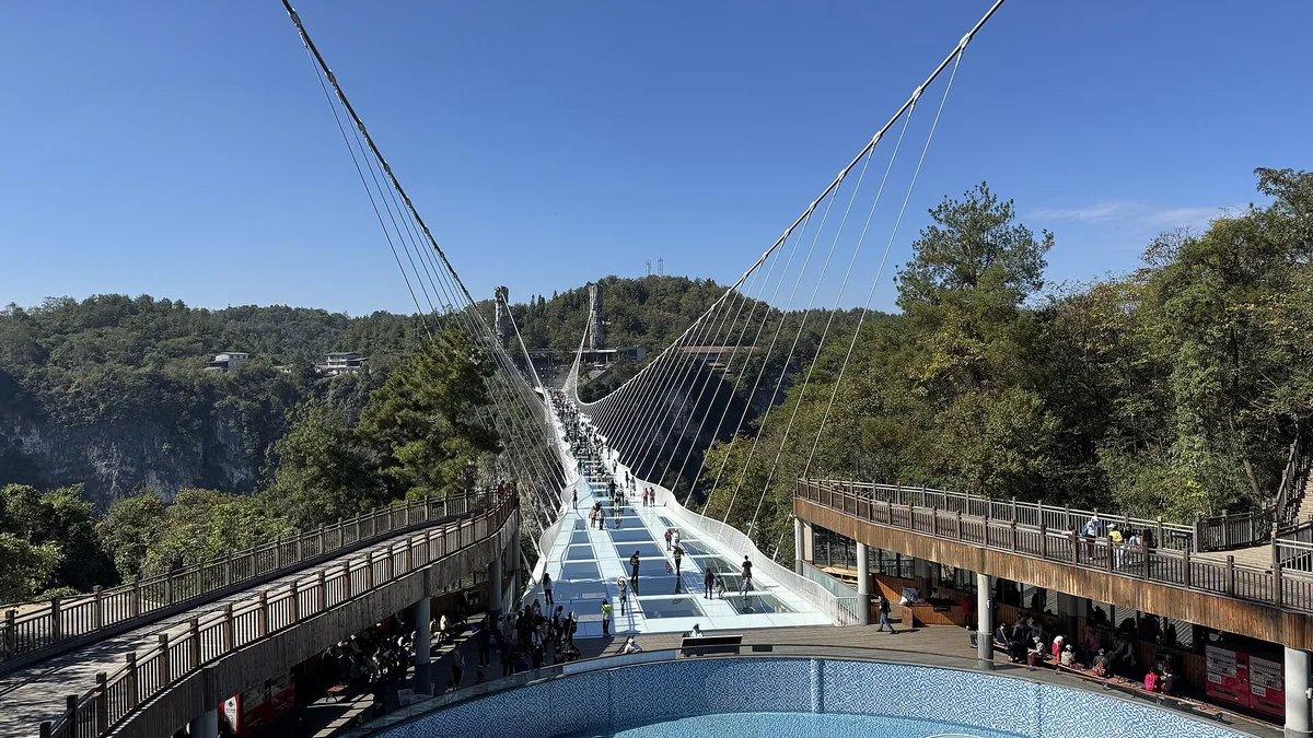 Visitors crossing the Zhangjiajie Grand Canyon glass bridge